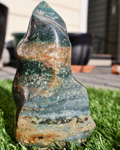 sparkling Ocean Jasper Crystal Flame, Hand Carved Decorative Sculpture, Multicolor 5-6" in displayed on surface